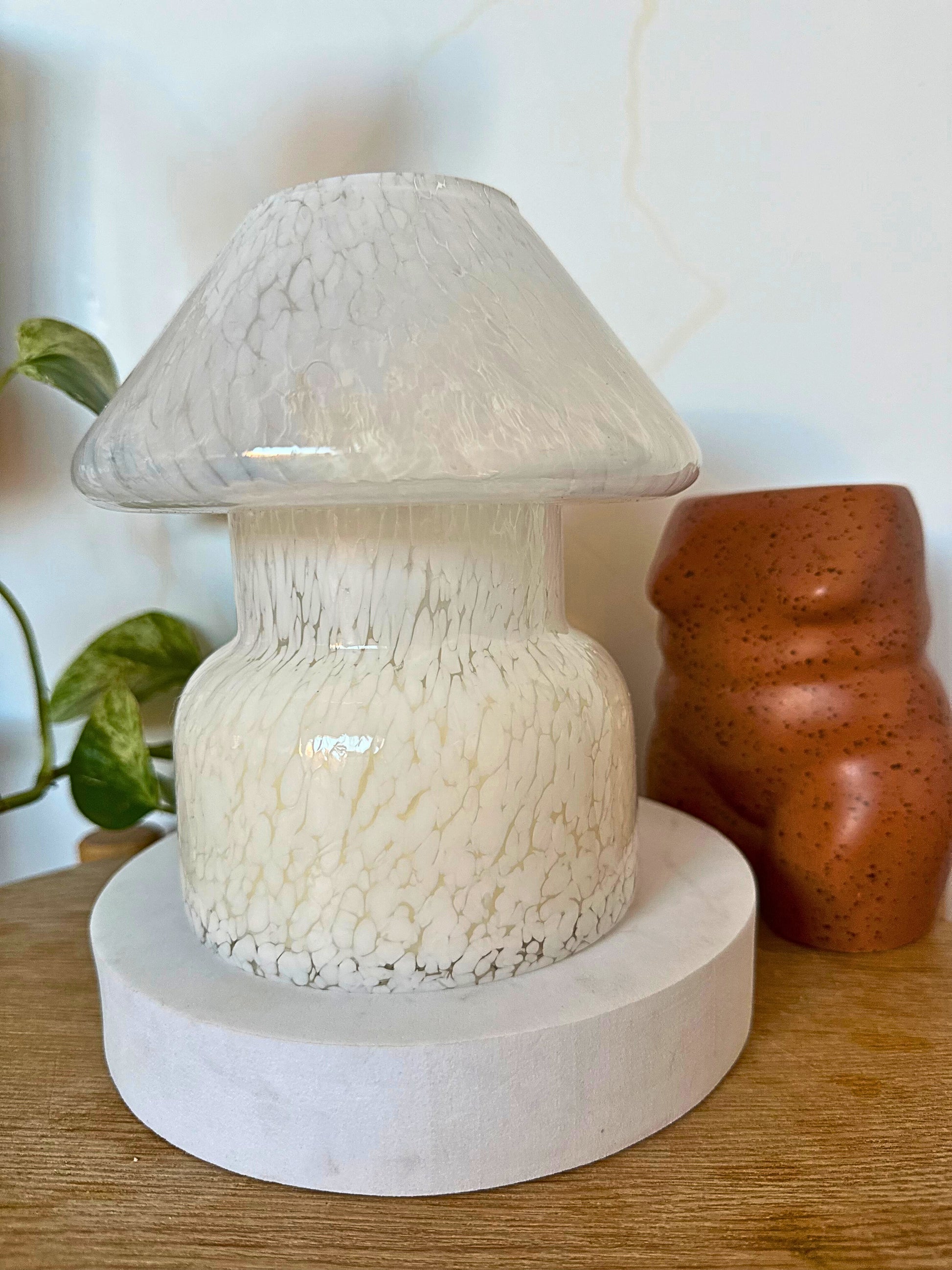 Mushroom-shaped lamp with textured design on a wooden surface