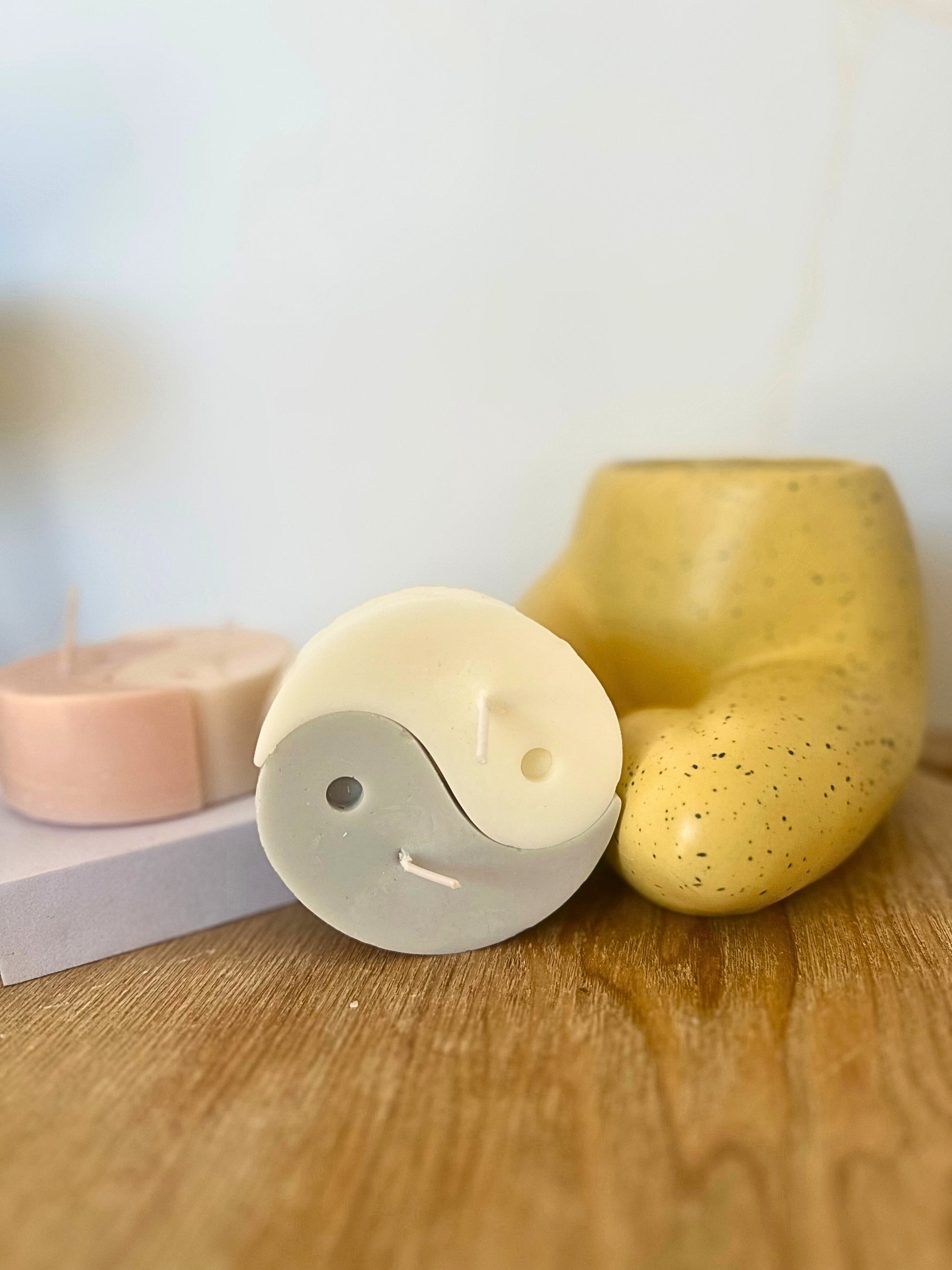 Three soap bars on a wooden surface with a blurred background